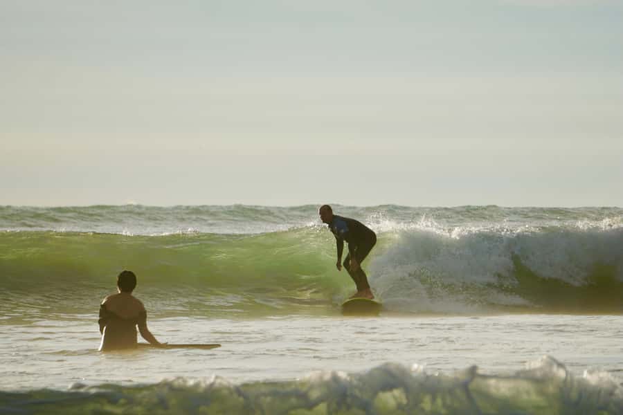 Auckland: Group Surfing Lesson with Muriwai Surf School - Booking flexibility and timing
