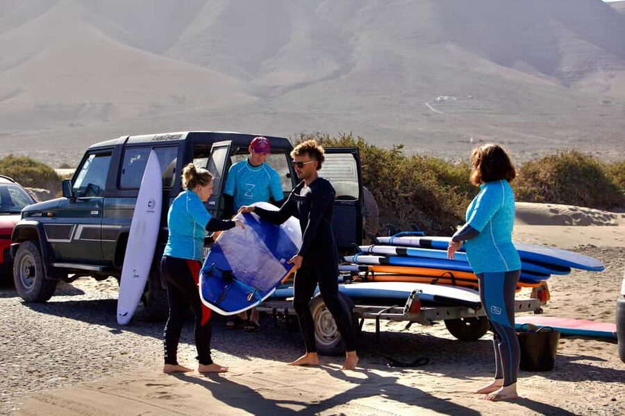 Group surf lessons in Lanzarote, learn with a local team - Learning the basic moves on the beach