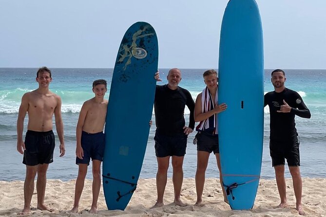 Learn to Surf in Paradise. - Taking the board into the waves