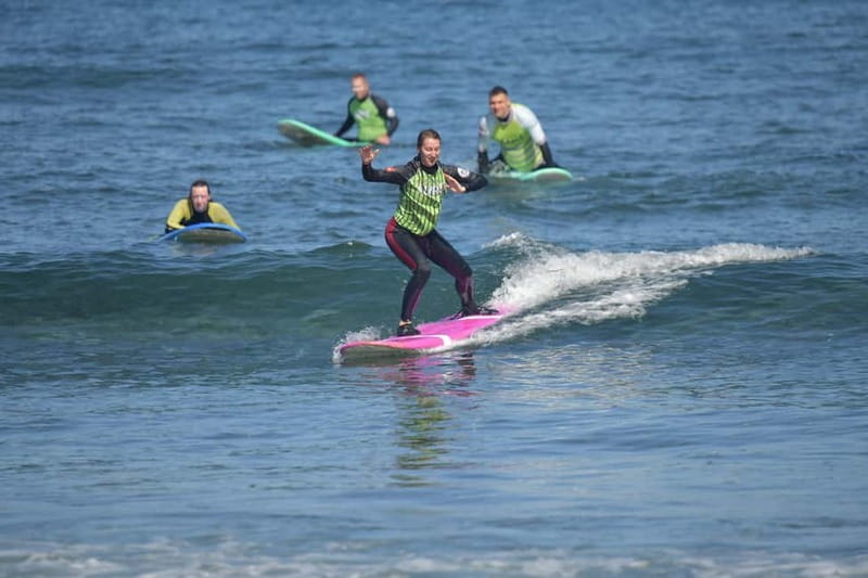 Playa de Las Americas: Surfing Lesson with Photo Analysis - Entering the water with an instructor nearby