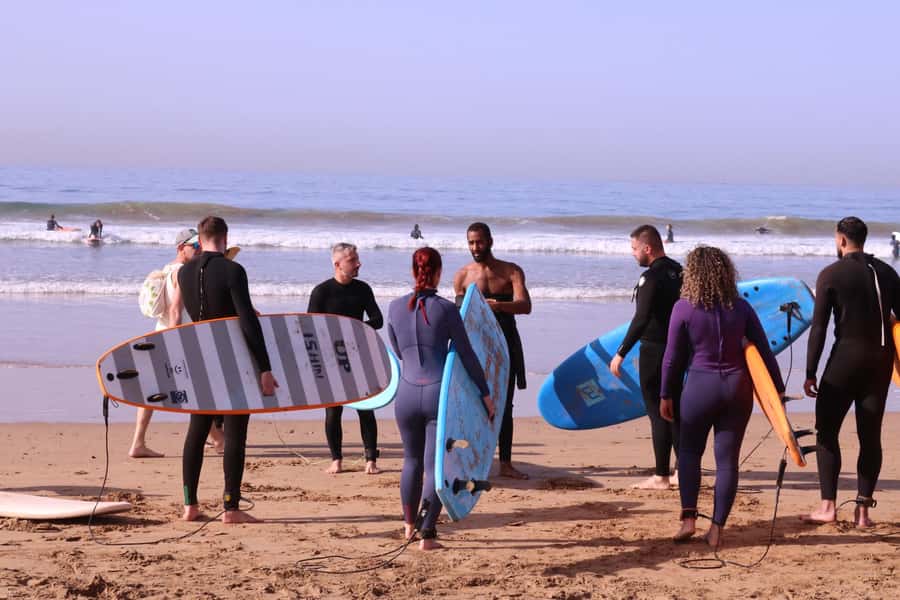 Surf Lessons with Local instructor - Carrying the Board to the Beach